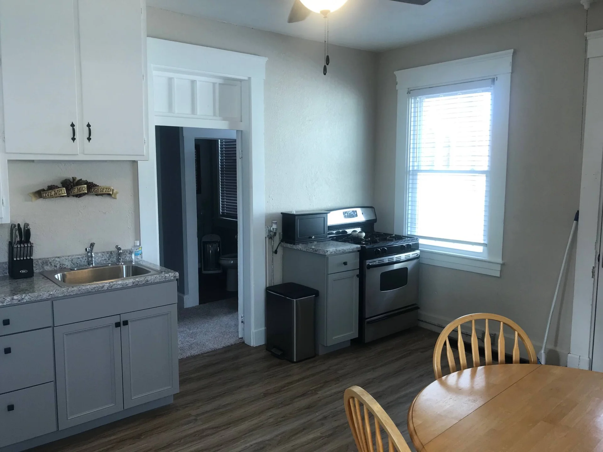 Actual kitchen with dining table and cooking appliances